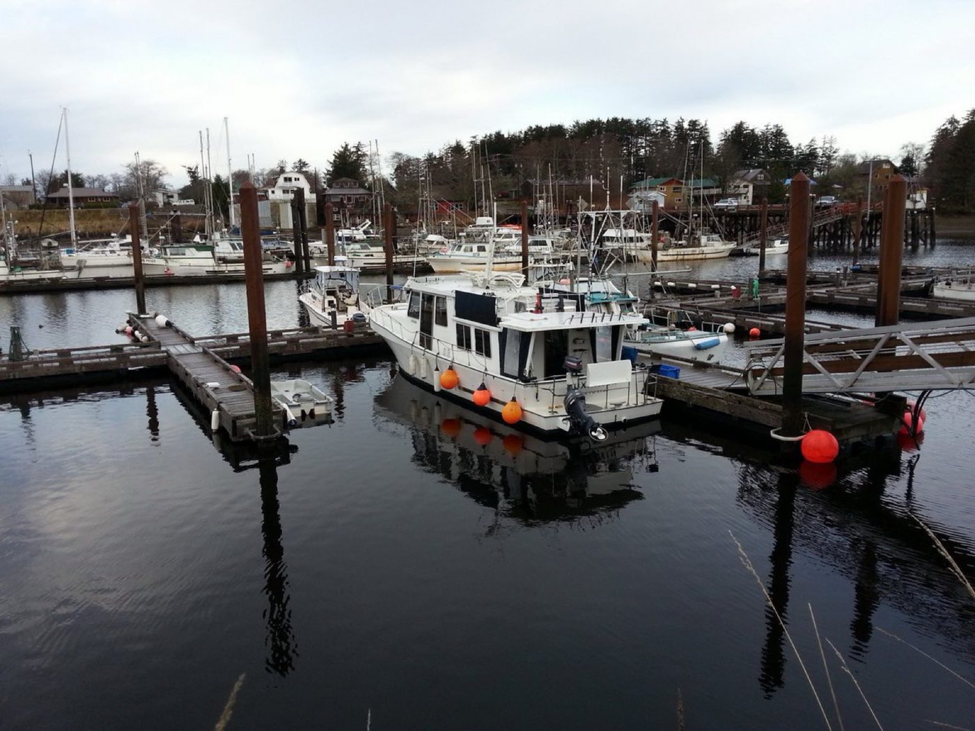 Small-town working marina with wooden docks and moored boats